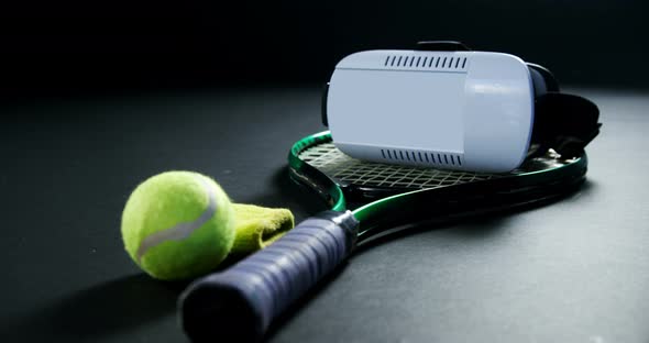 Tennis balls, racket and virtual reality headset in studio 4k