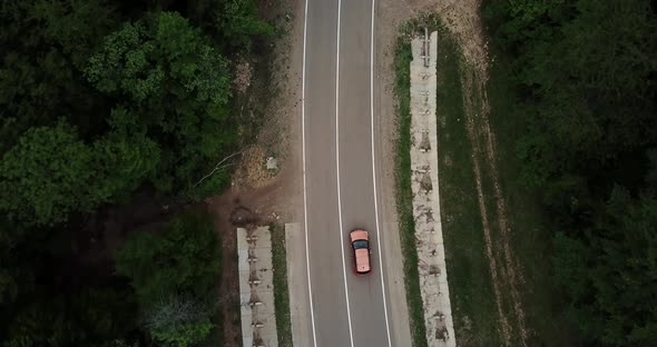 Drone Point of View Tracking Mode Aerial View Flying Over Two Lane Countryside Forest Road with