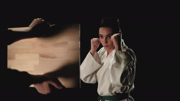 Young Woman in Kimono Breaks a Wooden Board