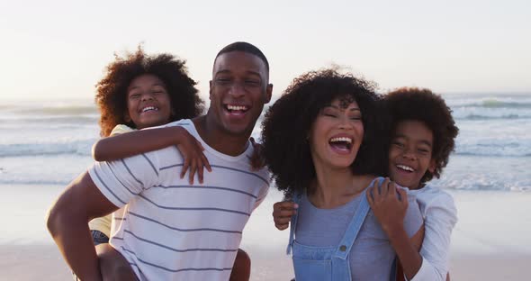Portrait of african american family smiling together at the beach