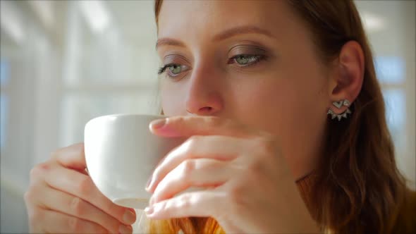 Beautiful Sunny Day Young Woman Drinks Morning Coffee in a Cafe, Making Online a Purchase Easy