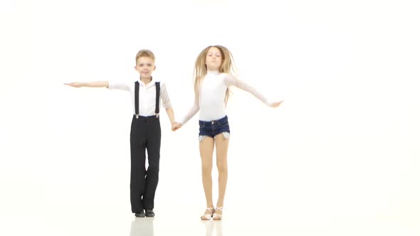 Little Dancers in Beautiful Costumes Perform a Retmic Dance