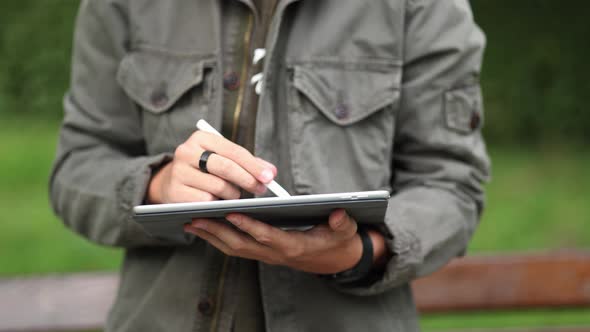 Closeup of Boy Painting in Tablet Using Pencil