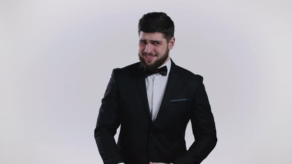 Young Man in Tuxedo Showing Gesture of Nonsense Not Serious