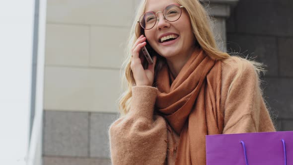 Happy Young Girl Smiling Talking on Phone Bottom View Caucasian Female Shopper Attractive Millennial