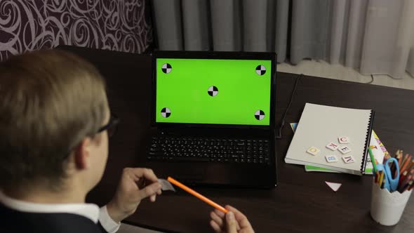 Man Teacher Making Online Video Call on Laptop. Green Screen. Distance Education