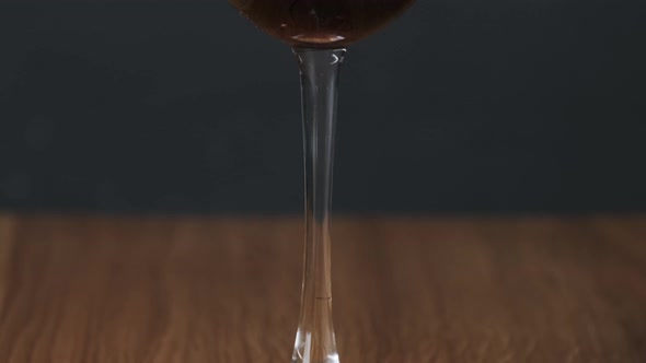 Mulled Wine in a Glass with Straws in Restaurant on Black Background