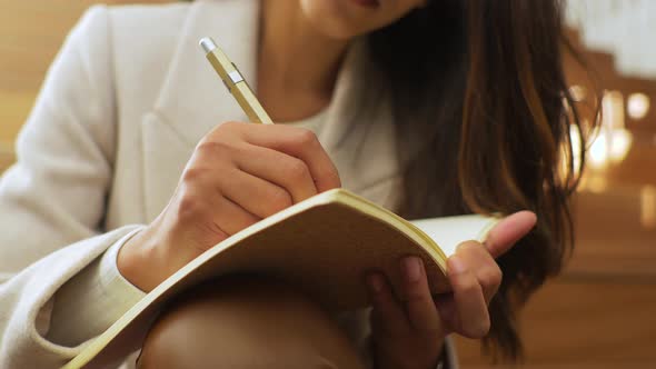 Slow motion shot of woman taking notes