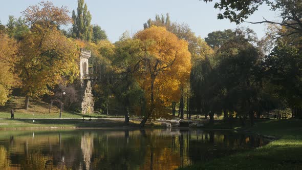 Beautiful reflections in the park lake slow tilt 3840X2160 UltraHD  footage - Autumn in Romanian cit