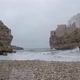 The waves of the Mediterranean Sea from Polignano a Mare, surrounded by rock walls and old buildings - VideoHive Item for Sale