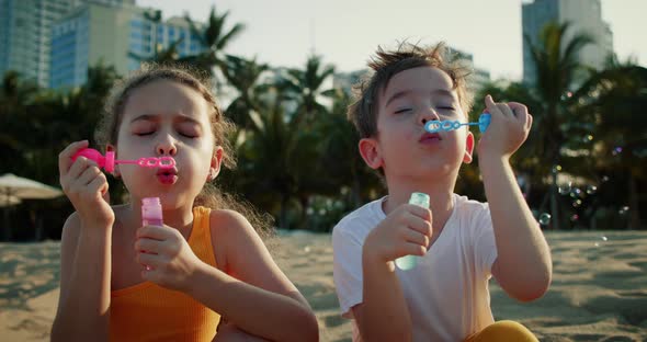 Happy Children Playing with Soap Bubbles