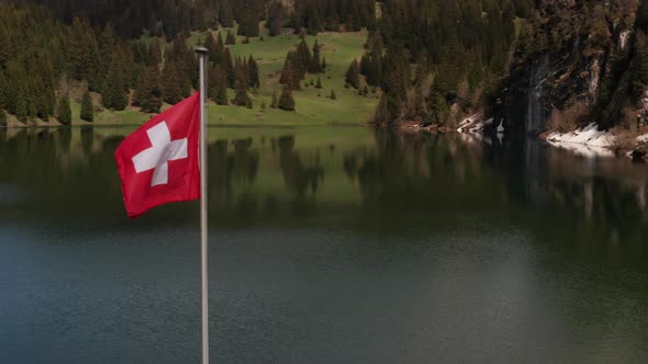 Flying past Swiss flag in beautiful lakeside area