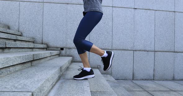 Fitness sports woman running up stairs in city