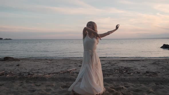 Graceful Girl Dancing on the Beach at Sunset