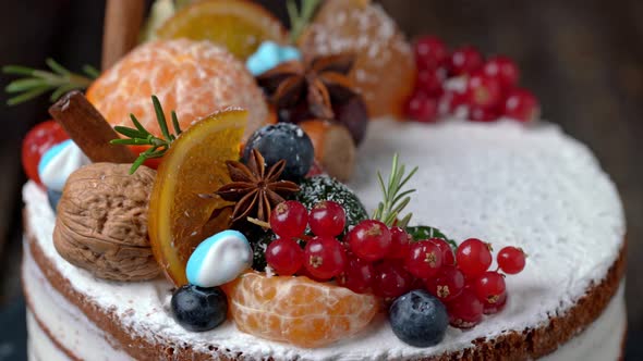 Festive New Years Cake Decorated with All Sorts of Fruits Spinning on a Rotating Stand