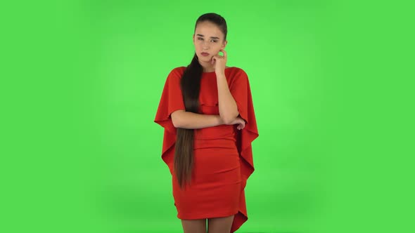 Pretty Young Woman Is Focused Thinking About Something, No Idea. Green Screen