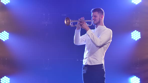 A Man Enthusiastically Plays the Trumpet Indoors. Slow Motion. Close Up.