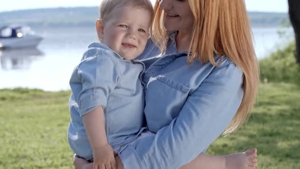 Young Mother Holding Cute Toddler