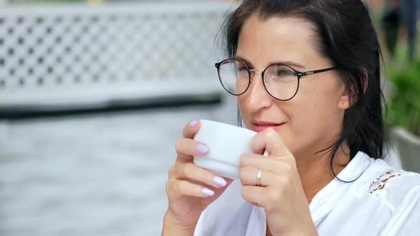 Closeup Smiling Relaxed Casual Young Woman Drinking Coffee at Outdoor Cafe Having Positive Emotion