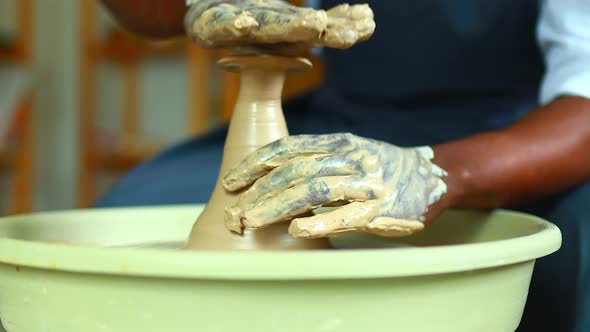 Positive Latin Hispanic Brazilian Man Making Ceramic Pot on Pottery Wheel