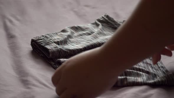 Men use their hands to fold men's underwear to keep it organized and easy to store and use. 4K, 29.9