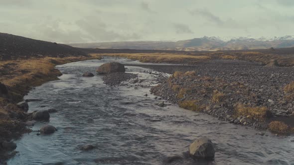 Streaming water of cold river in rocks