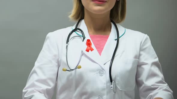 Woman Physician With Red Ribbon Posing for Camera, AIDS Awareness, Sti Disease