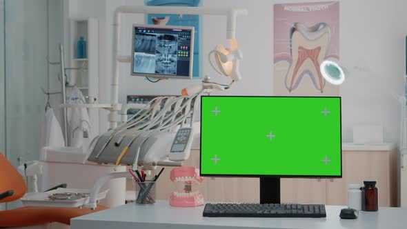 Empty Dental Cabinet with Horizontal Green Screen on Monitor