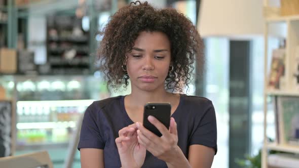 Portrait of Loss on Smartphone By Young African Woman