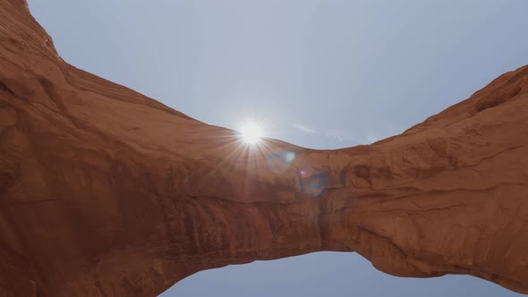 Sun Beam Through An Rock Arch Of Red Orange Colored In Arches National Park