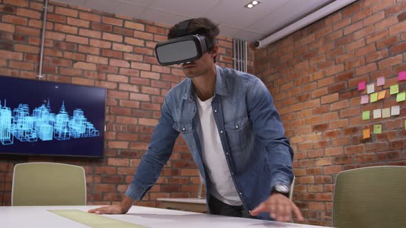 Creative businessman using virtual reality headset in modern office