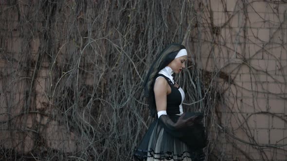 Portrait of a Woman with Red Lipstick on Lips and in a Nun's Costume