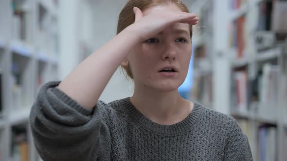 Searching Gesture By Young Woman Sitting in Cafe