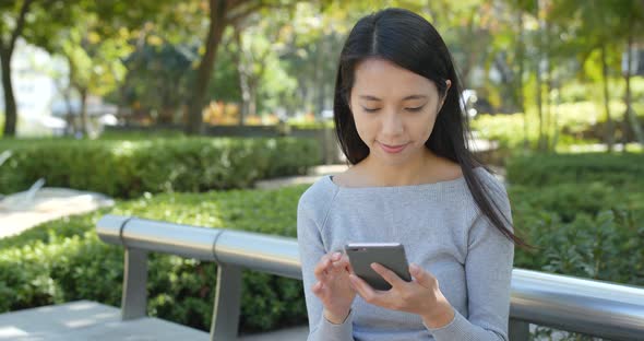 Woman use of mobile phone in the park