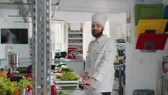 Portrait of Male Cook Sitting in Professional Gastronomy Kitchen