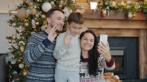 Slow Motion of Happy Family Making Online Video Call on Christmas Day Using Smartphone