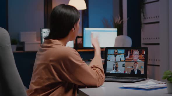 Overworked Businesswoman Discussing with Remote Partners on Laptop