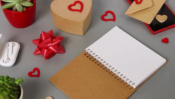 Opened notebook near valentine's day card and present Zoom in