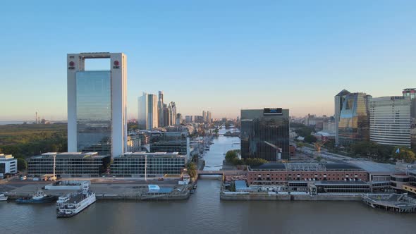 Cinematic aerial pull out shot at Purerto Madero north port with beautiful diffused sunset hitting o