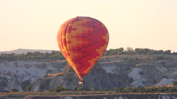 Hot Air Balloon Flying Over Hoodoos and Fairy Chimneys in Goreme Valley Cappadocia, Urgup Turkey