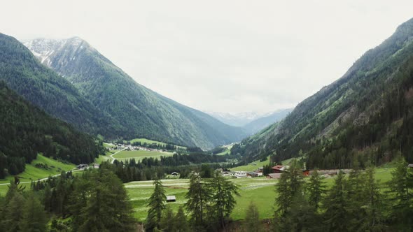 Panoramic View of a Picturesque Mountain Valley with a Village in a Lowland