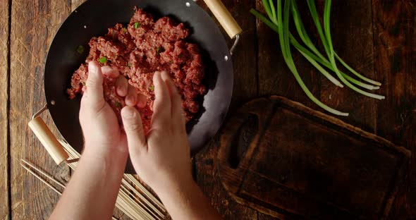 Men's Hands Make Homemade Raw Kebab Sausages. 