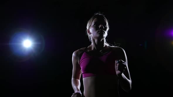 Horizontal Shot From Left To Right Running Female Athletes Backlit on Black Background, Slow Motion