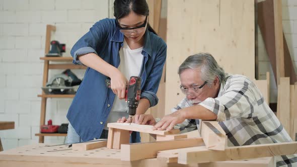 Carpenter use electric drill to drill wood