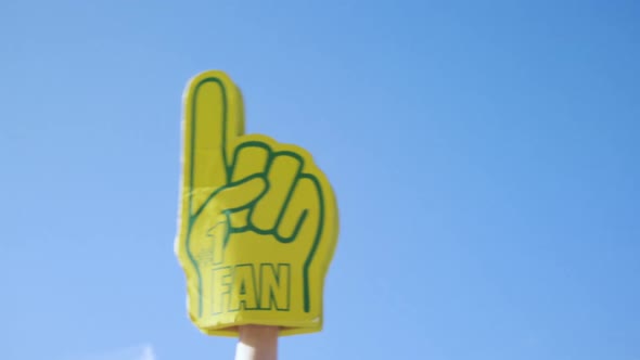 Foam hand waving against blue sky 4k