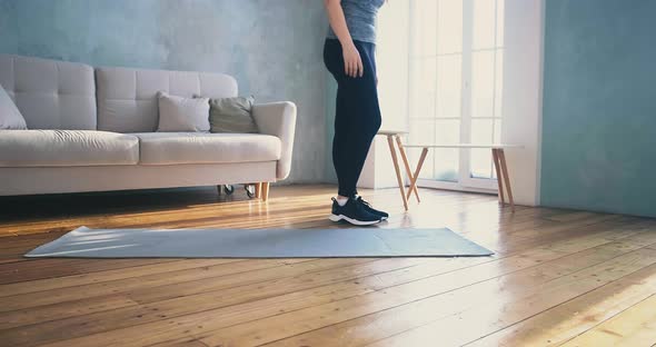 Woman Lies Down on Mat Do Sports Exercises