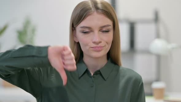 Portrait of Thumbs Down Gesture By Young Woman