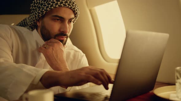 Thoughtful Muslim Working Laptop on Business Trip Closeup