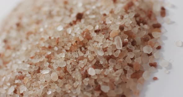 Video of pile of himalayan pink salt on white background