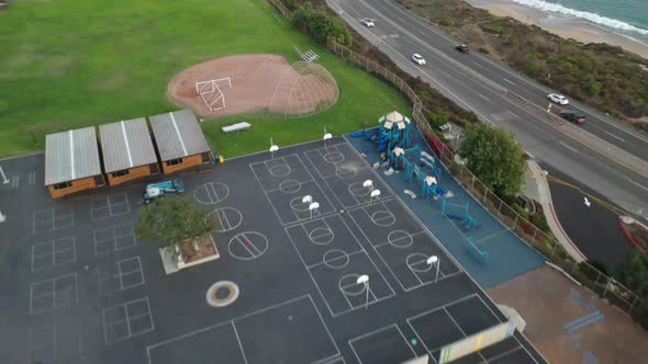 Flying Over An Empty Playground By The Ocean